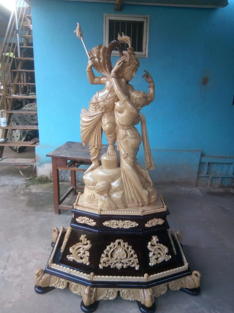 Standing wooden idol with carved halo and lotus base
