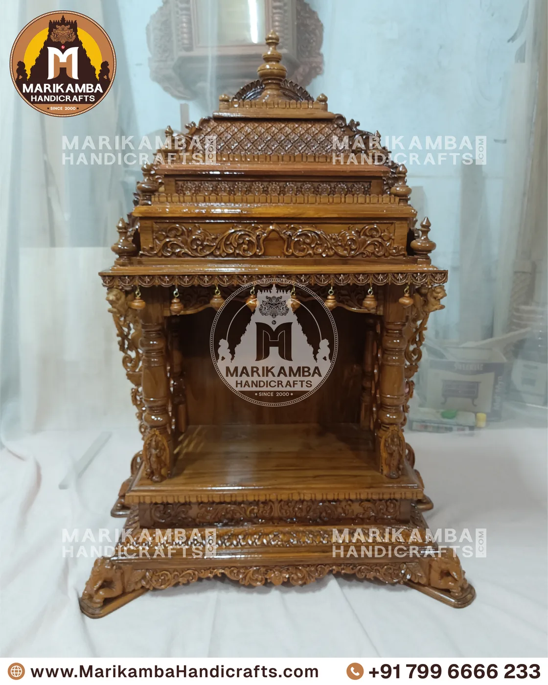 Compact wooden pooja unit with carved doors, drawers and a bell-motif valance — piece 76 of the collection