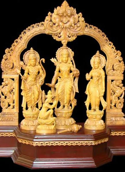 Wooden idol carved in the round, with detailed drapery and ornament