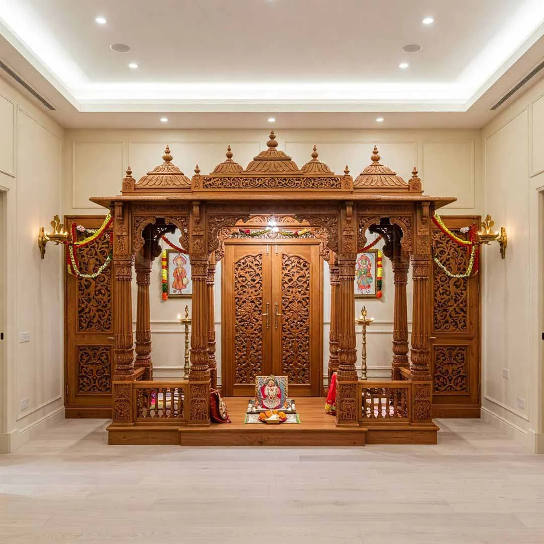 Carved wooden pooja unit design reference with panelled doors and a deity niche (reference 19)