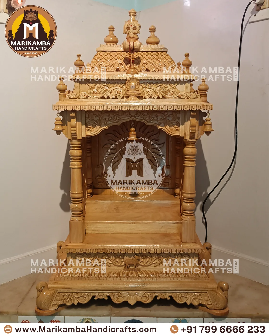 Compact wooden pooja unit with carved doors, drawers and a bell-motif valance — piece 96 of the collection