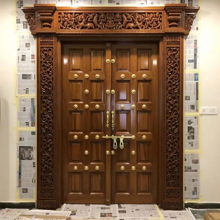 Entrance doorway reference showing carved jambs and a toranam-style top panel