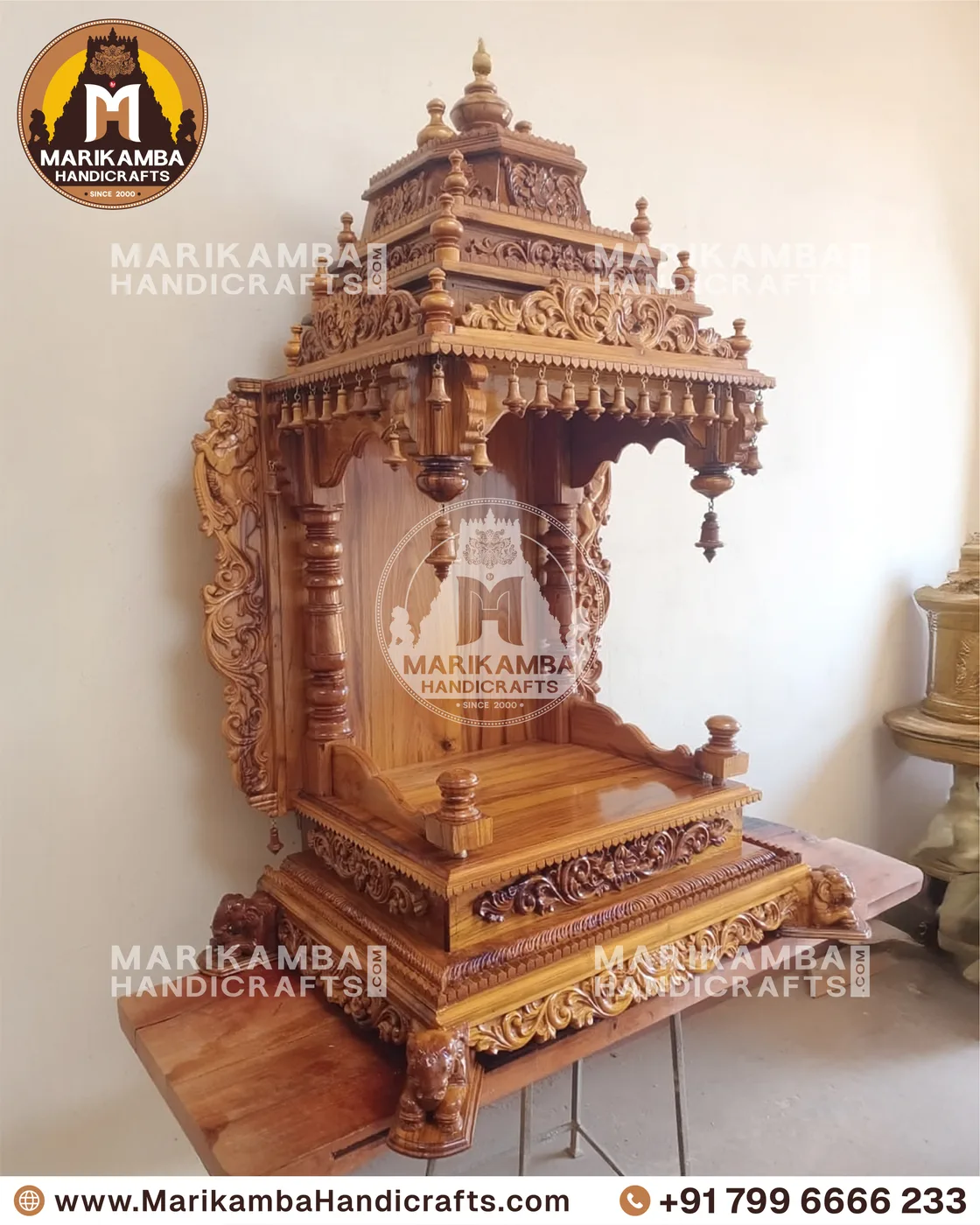 Compact wooden pooja unit with carved doors, drawers and a bell-motif valance — piece 126 of the collection