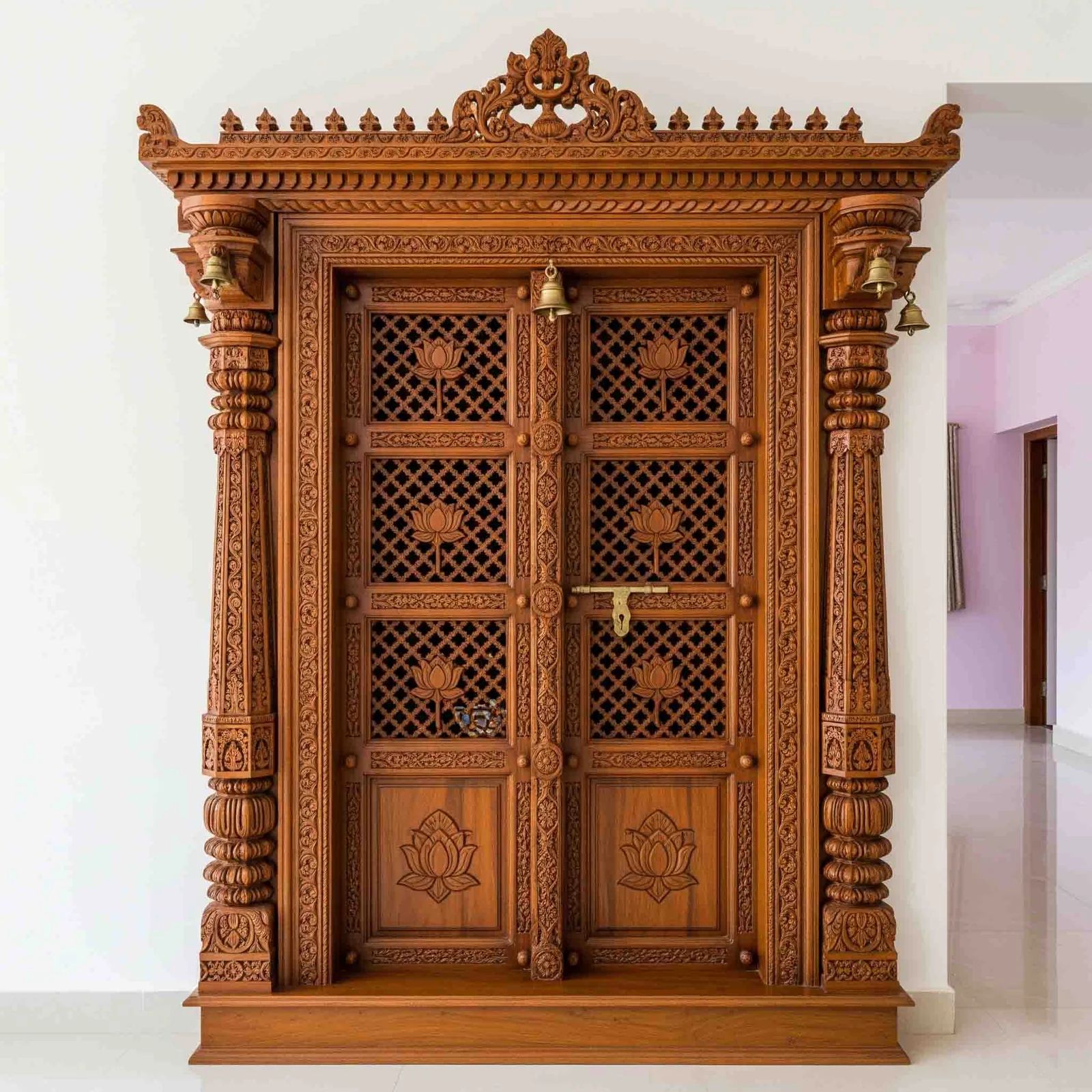 Carved wooden pooja unit design reference with panelled doors and a deity niche (reference 49)